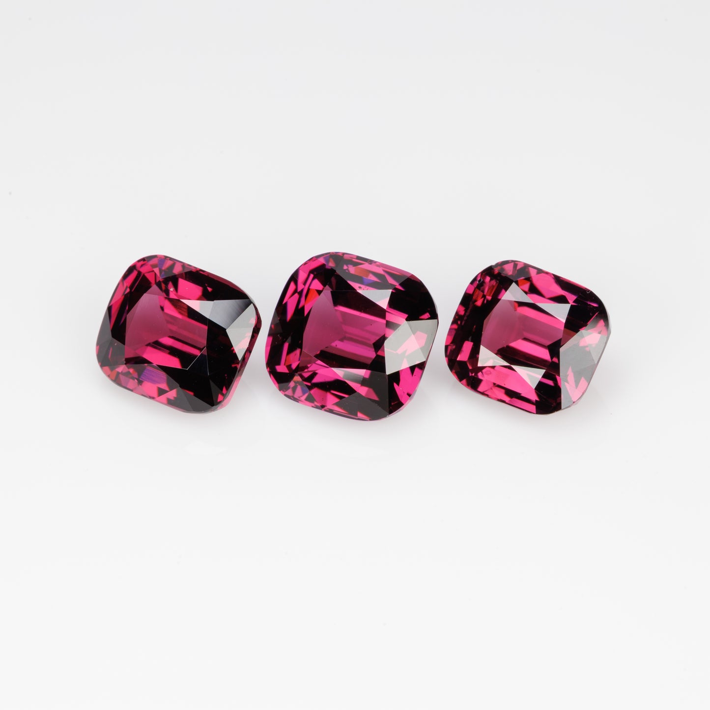 10.5 cts, Faceted rhodolite garnet cushion set the pair's