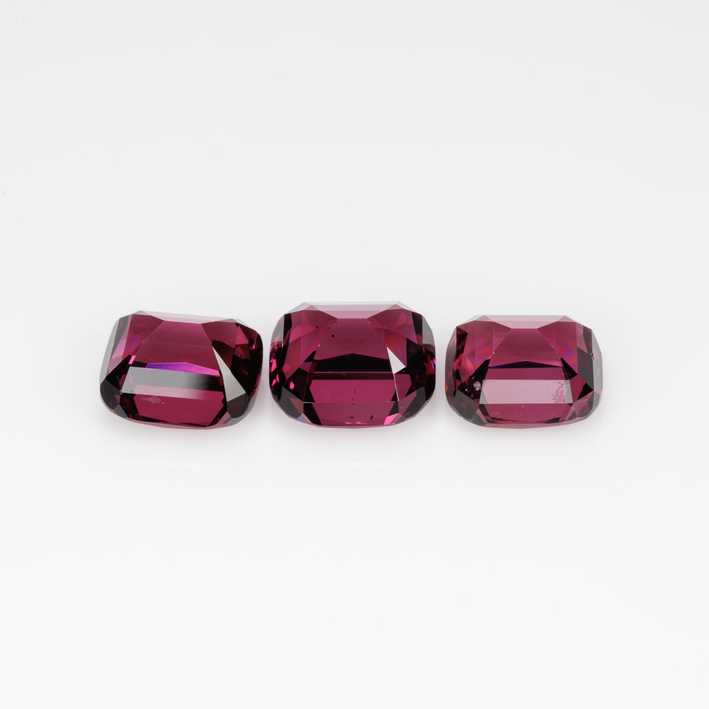 10.5 cts, Faceted rhodolite garnet cushion set the pair's
