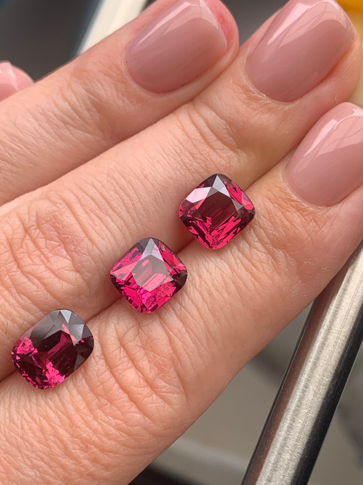 10.5 cts, Faceted rhodolite garnet cushion set the pair's