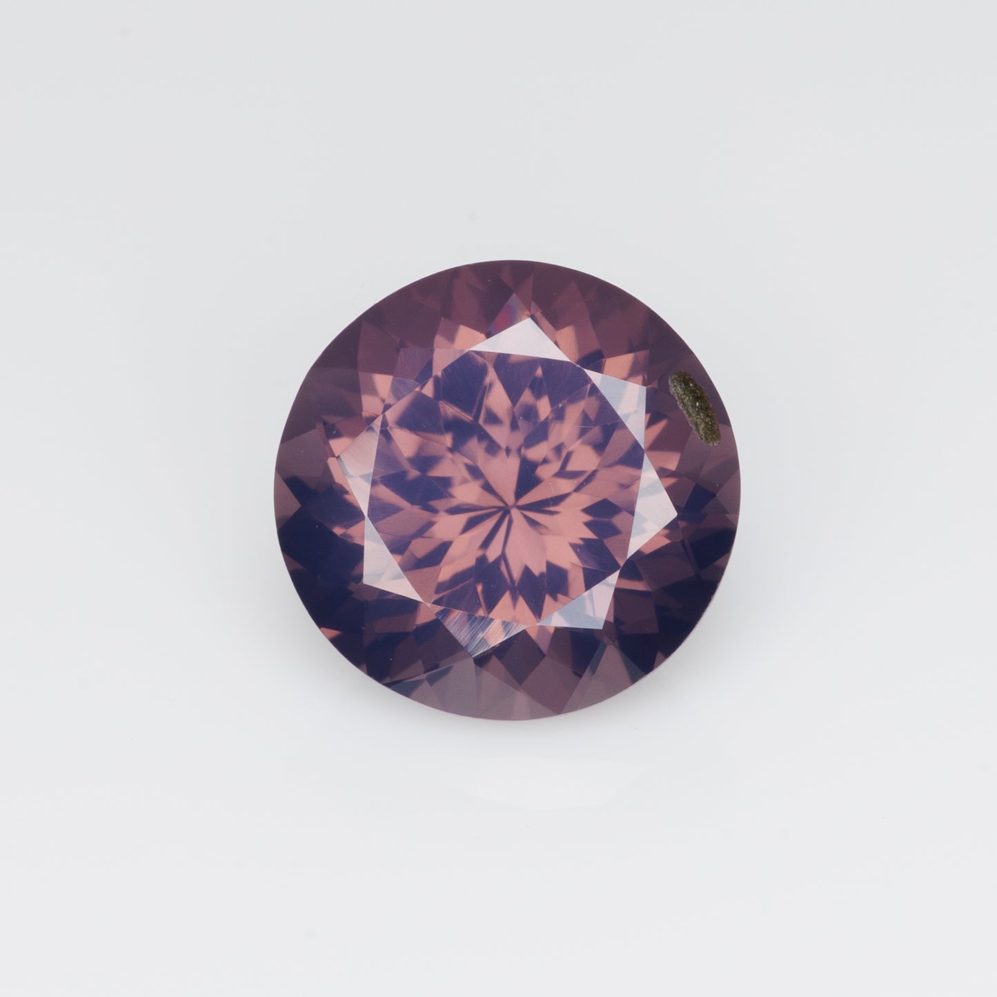 3.14 cts, Orangish purple milky faceted round spinel, very unusual color