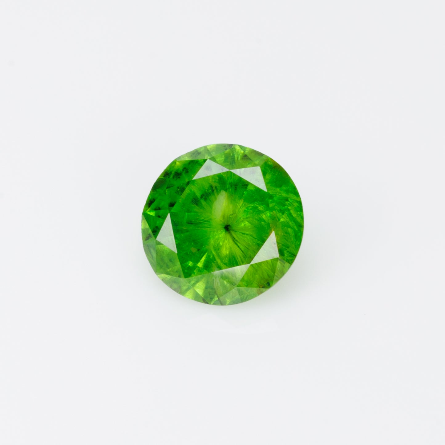 0.52 cts, Russian demantoid garnet with obvious horsetail inclusion