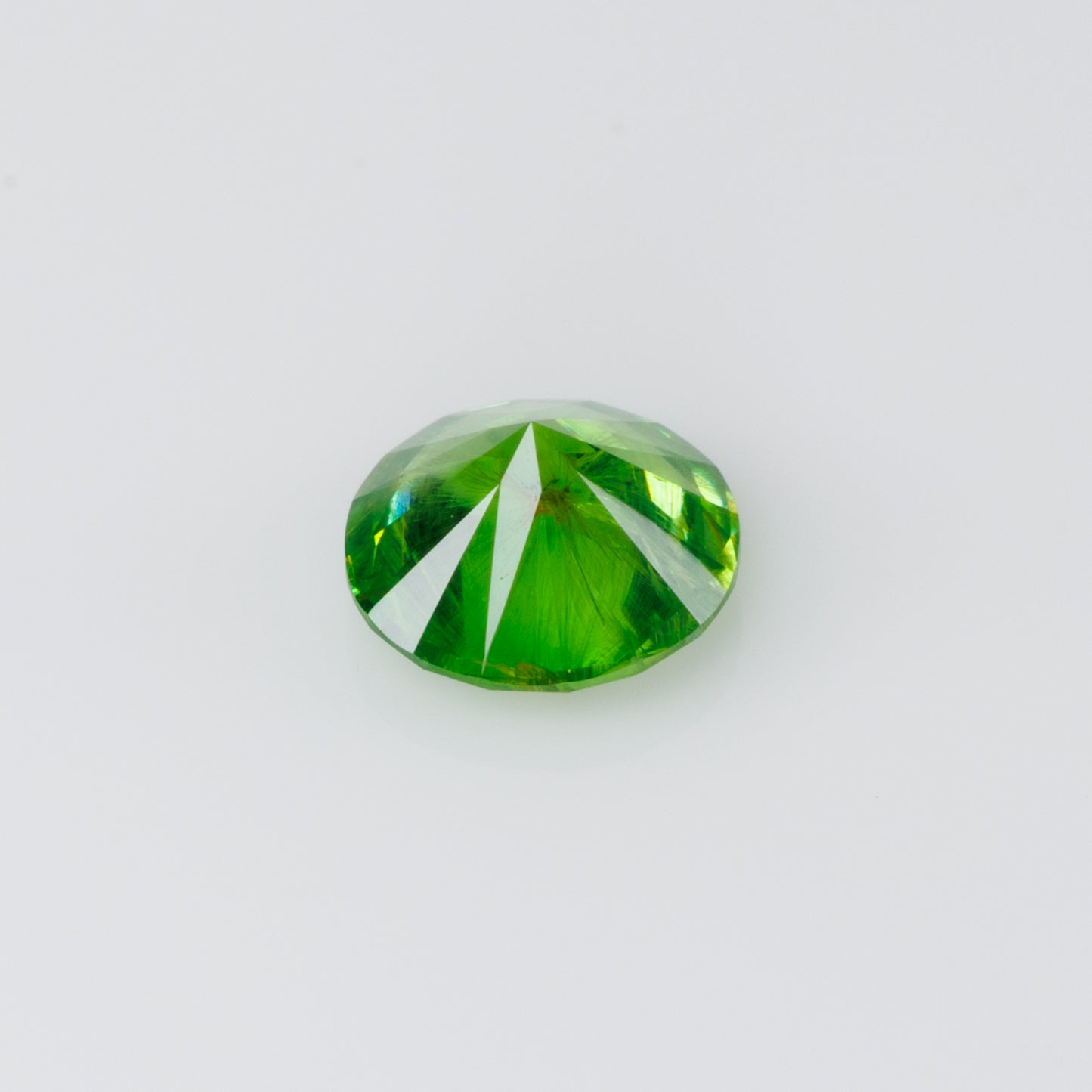 0.52 cts, Russian demantoid garnet with obvious horsetail inclusion