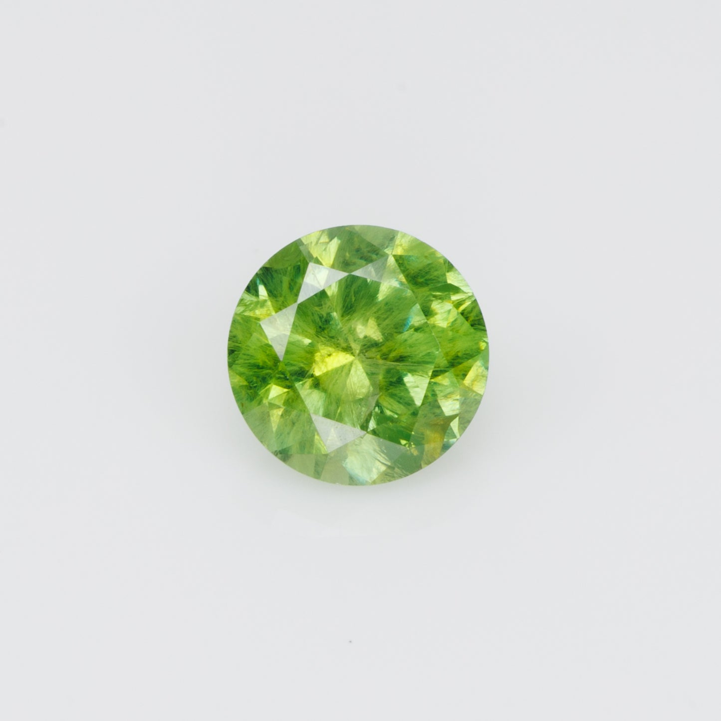 0.55 ct, Russian demantoid garnet with bissolite inclusions