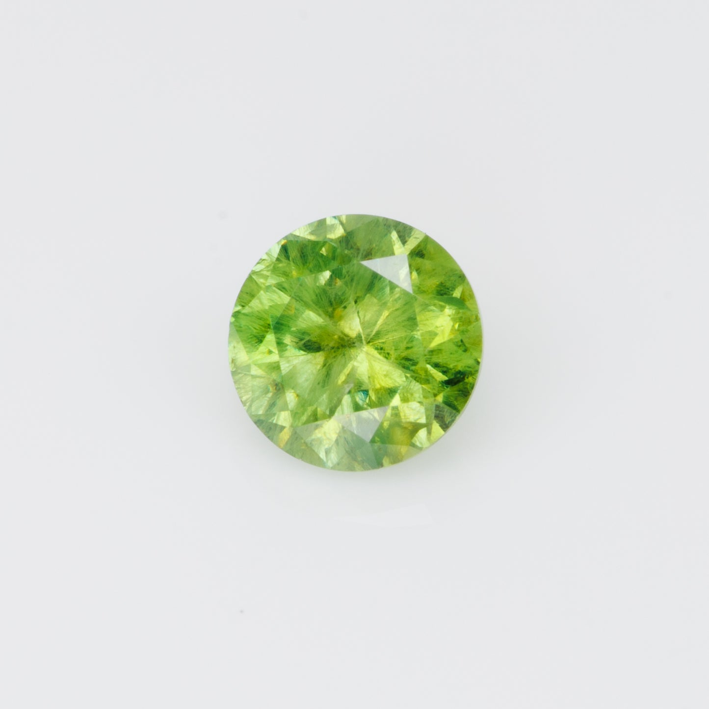 0.55 ct, Russian demantoid garnet with bissolite inclusions