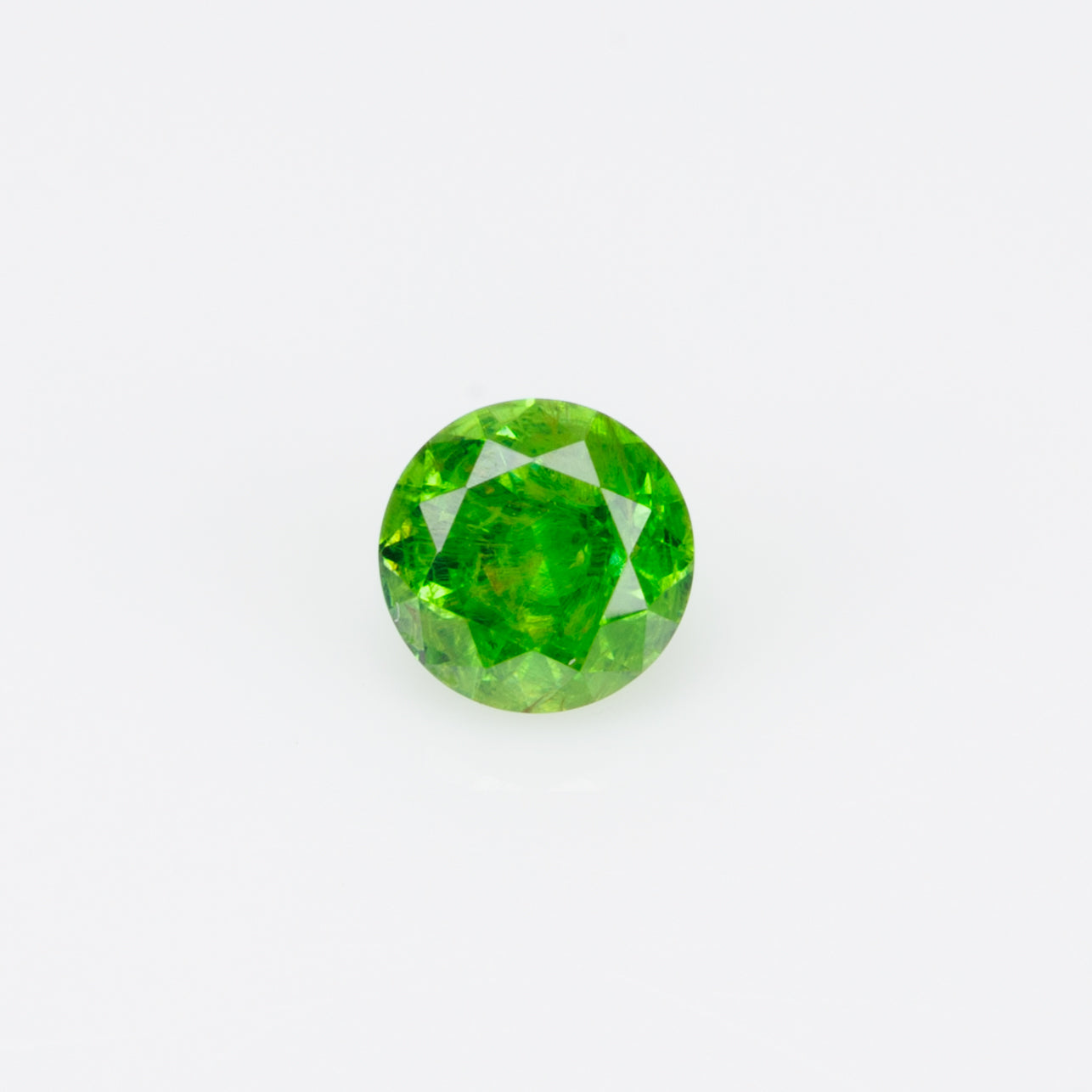 0.22 ct, Russian demantoid garnet with bissolite inclusions