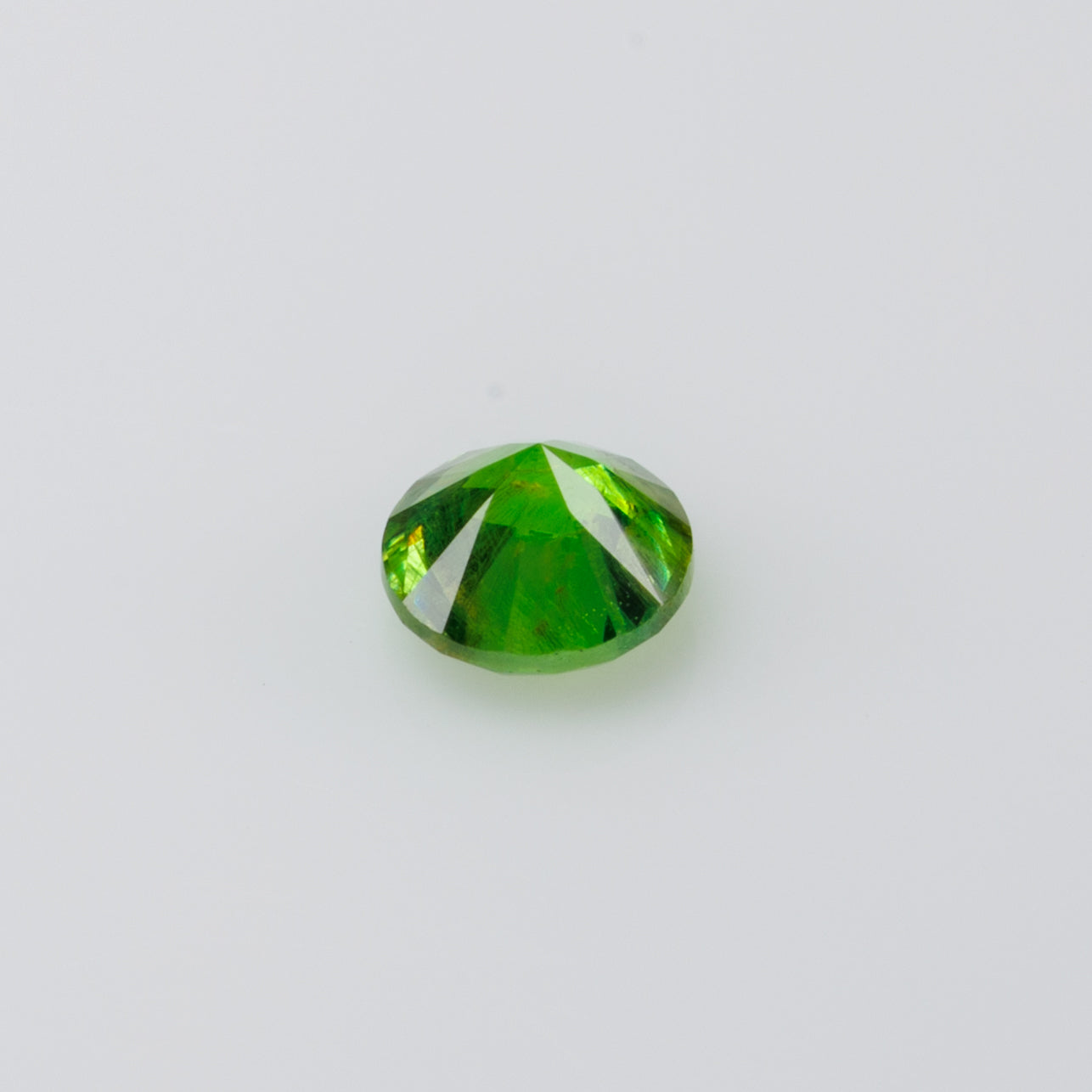 0.22 ct, Russian demantoid garnet with bissolite inclusions