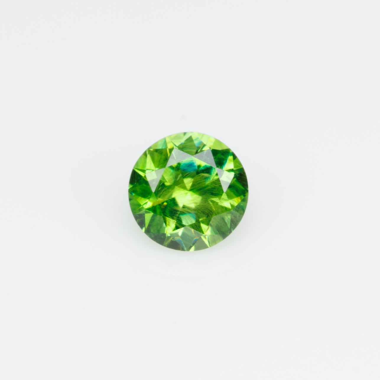 0.26 ct, Russian demantoid garnet with bissolite inclusions