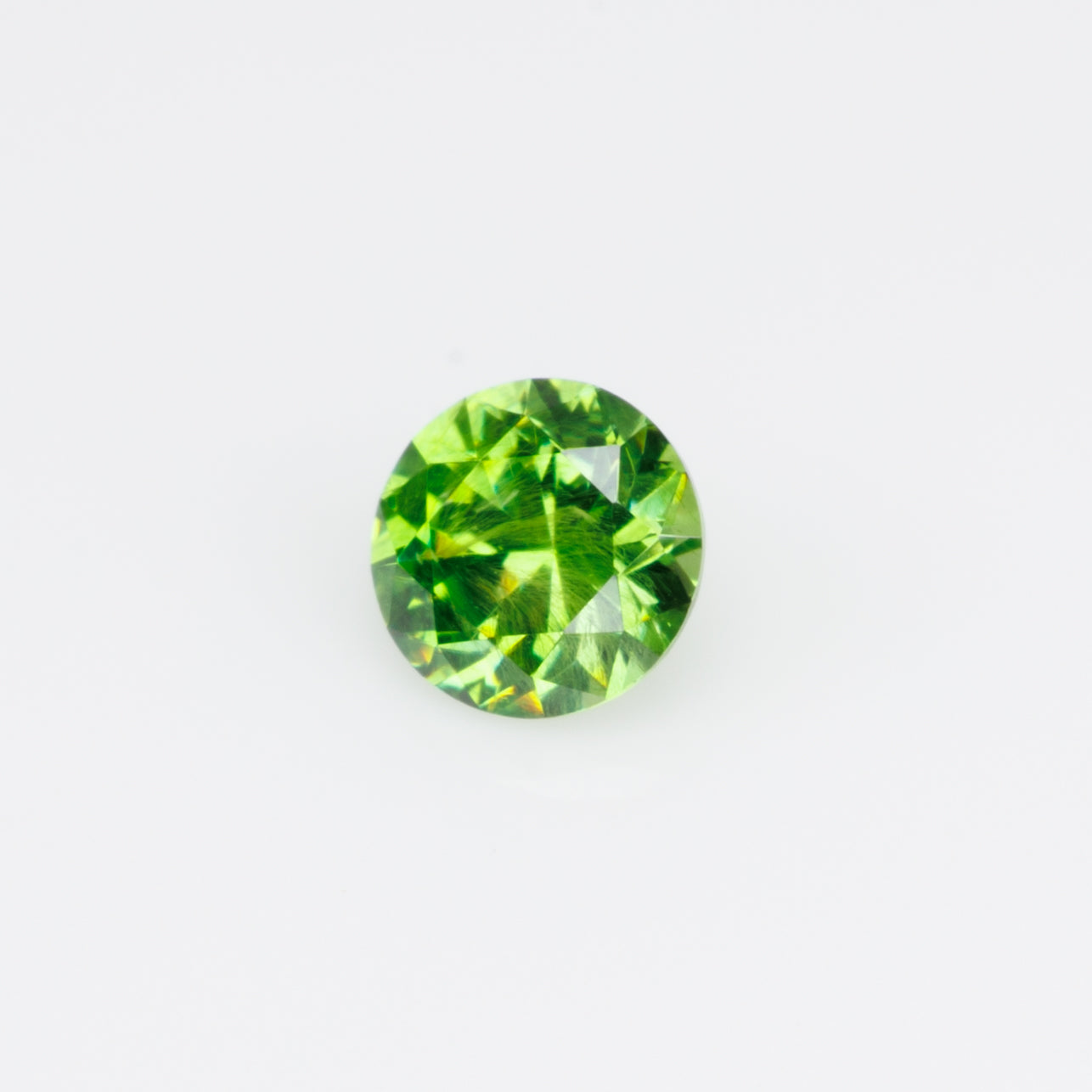 0.26 ct, Russian demantoid garnet with bissolite inclusions