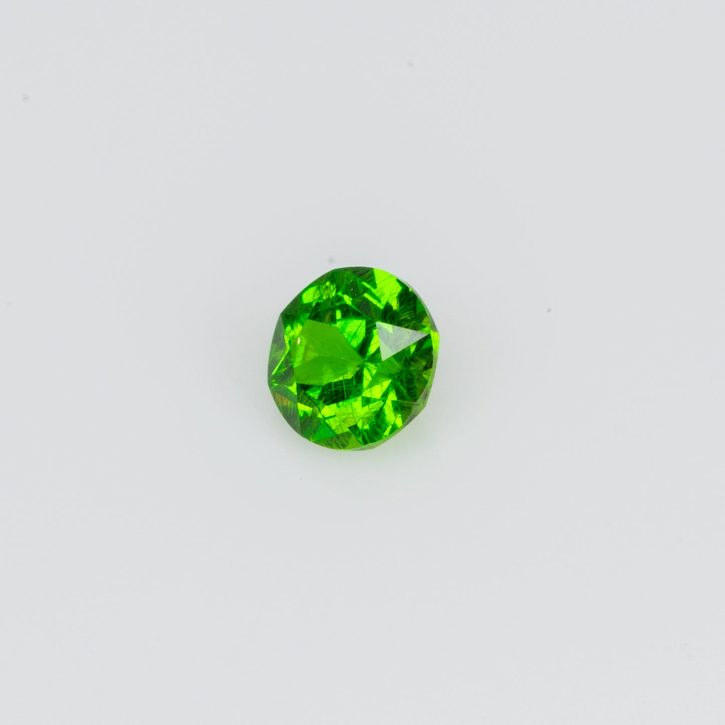 0.075 ct, Tiny vivid green faceted Russian demantoid garnet