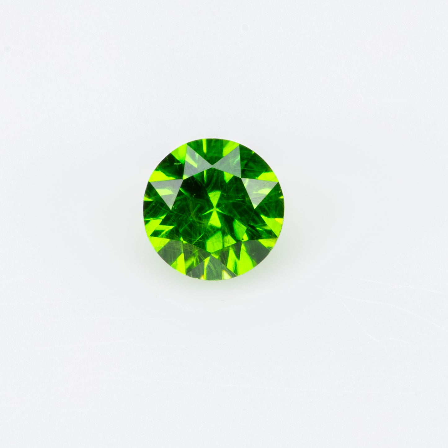 0.14 ct, Tiny vivid green faceted Russian demantoid garnet
