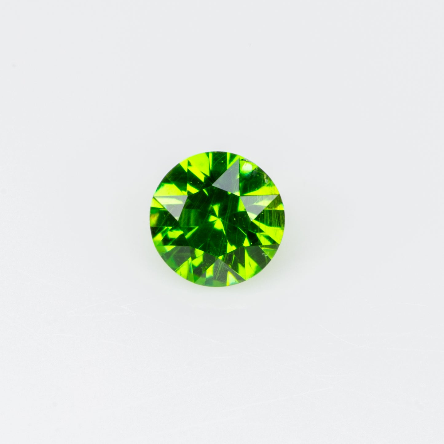 0.10 ct, Tiny vivid green faceted Russian demantoid garnet