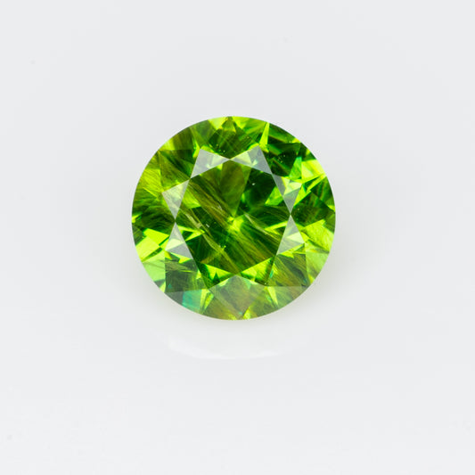 0.30 ct, Faceted Russian demantoid garnet with bissolite inclusions
