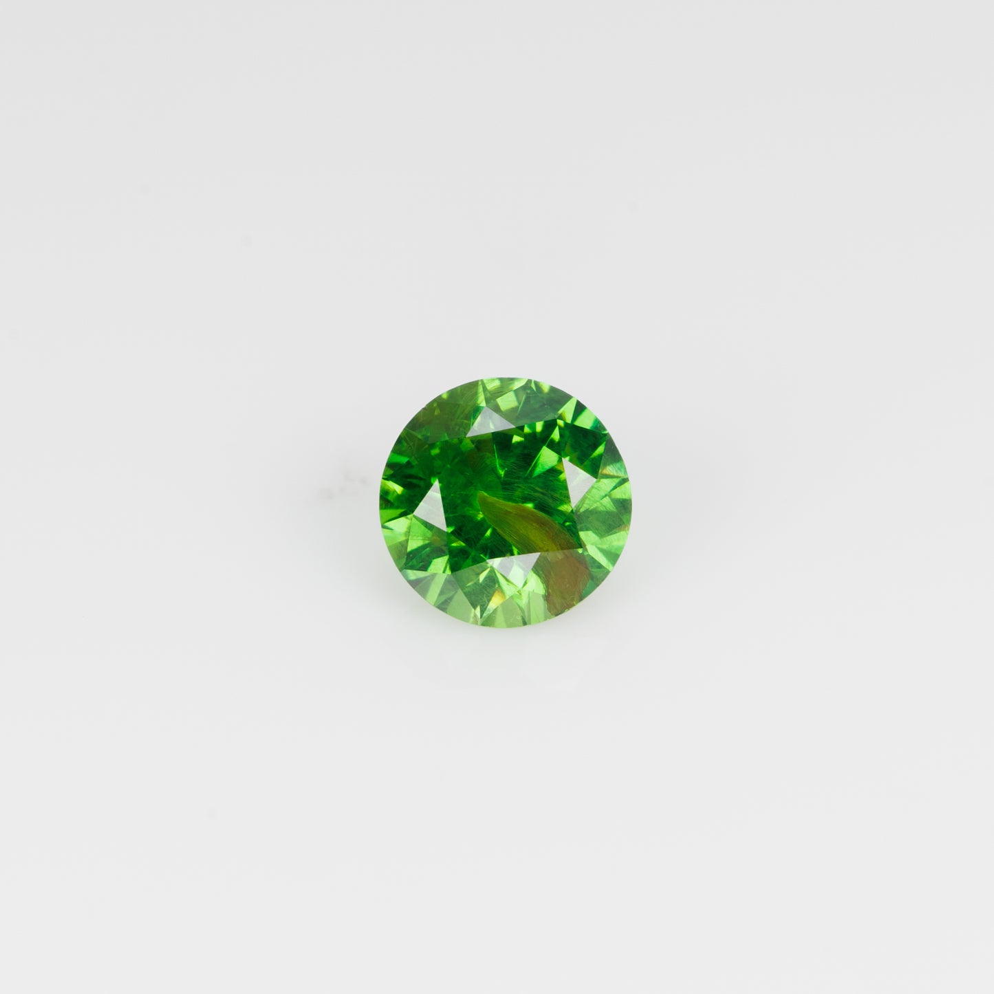 0.67 ct, Vivid green faceted Russian demantoid with byssolite inclusioms