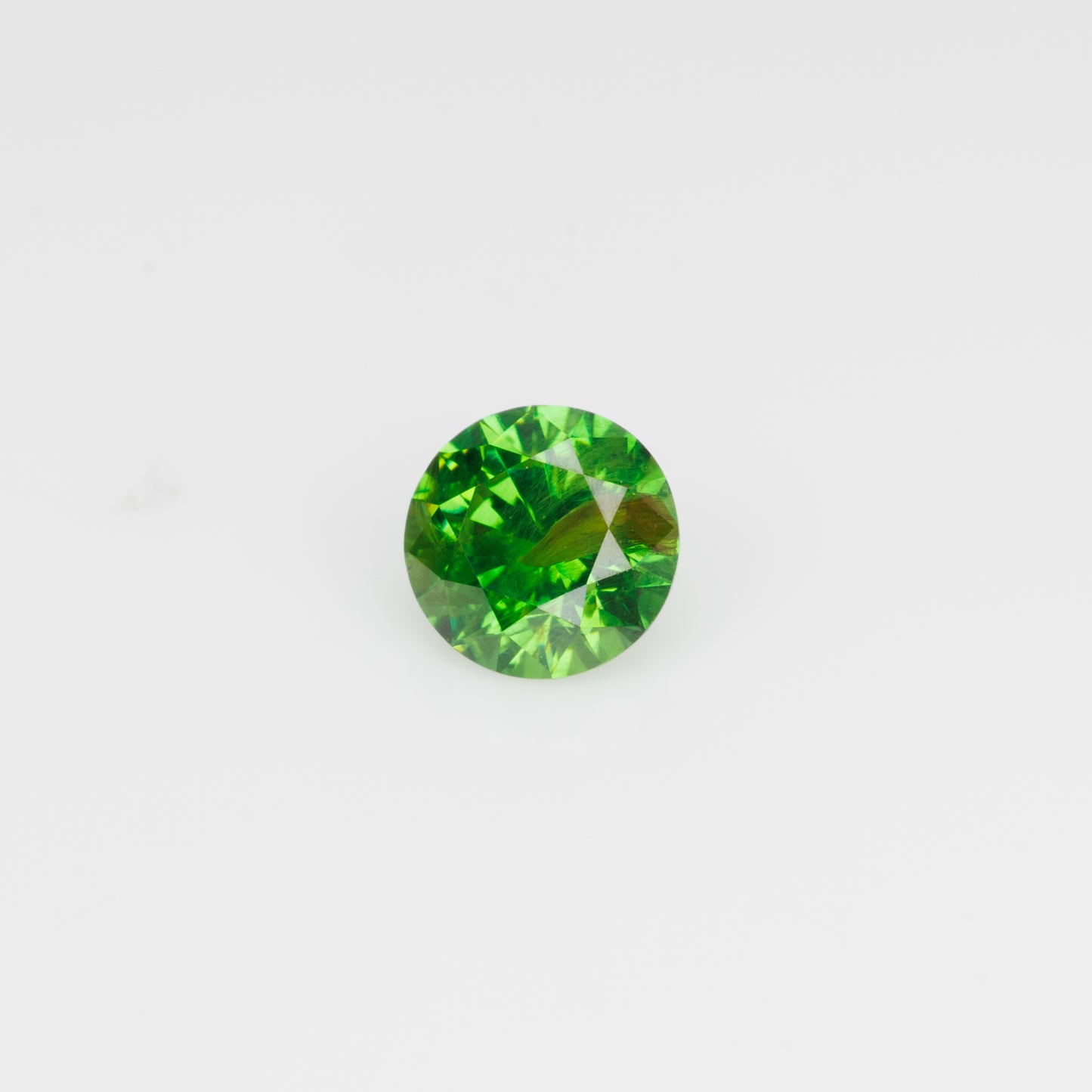0.67 ct, Vivid green faceted Russian demantoid with byssolite inclusioms