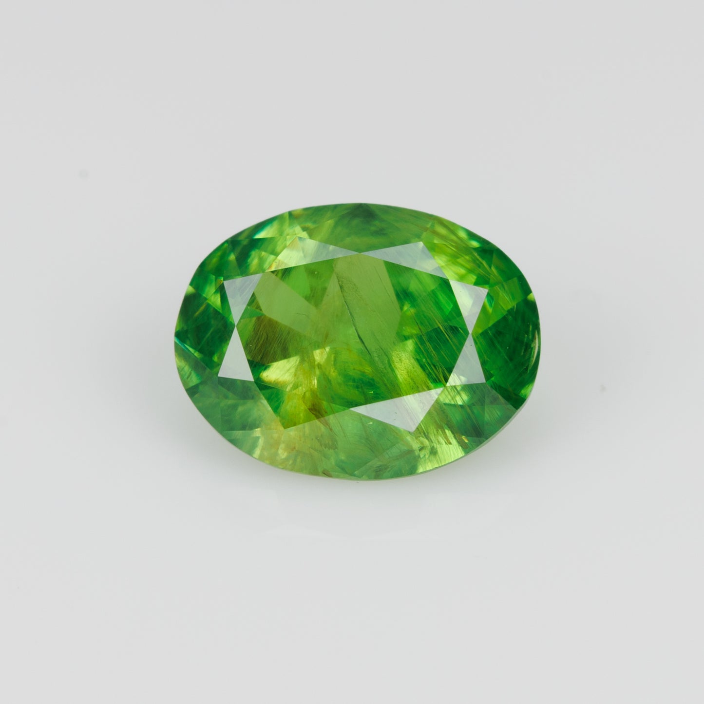 0.98 ct, Certified Russian faceted vivid apple green oval demantoid garnet with byssolite inclusions