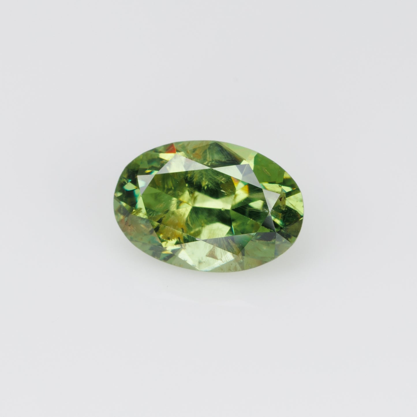 1.05 ct, Certified Russian faceted vivid green oval demantoid garnet with byssolite inclusions