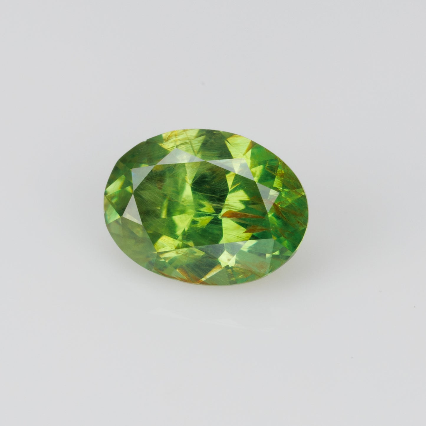 0.41 ct, Certified Russian faceted vivid green oval demantoid garnet with byssolite inclusions