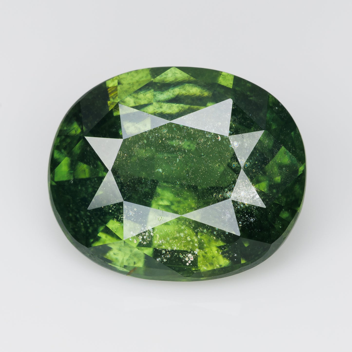 8 cts, Faceted vivid green zircon with amazing glow of the inclusions