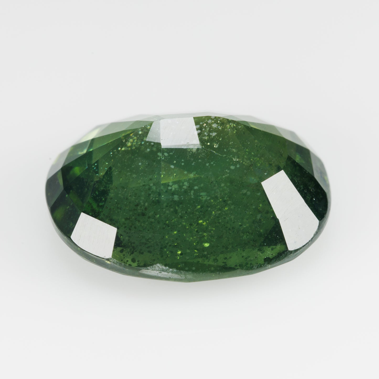 8 cts, Faceted vivid green zircon with amazing glow of the inclusions