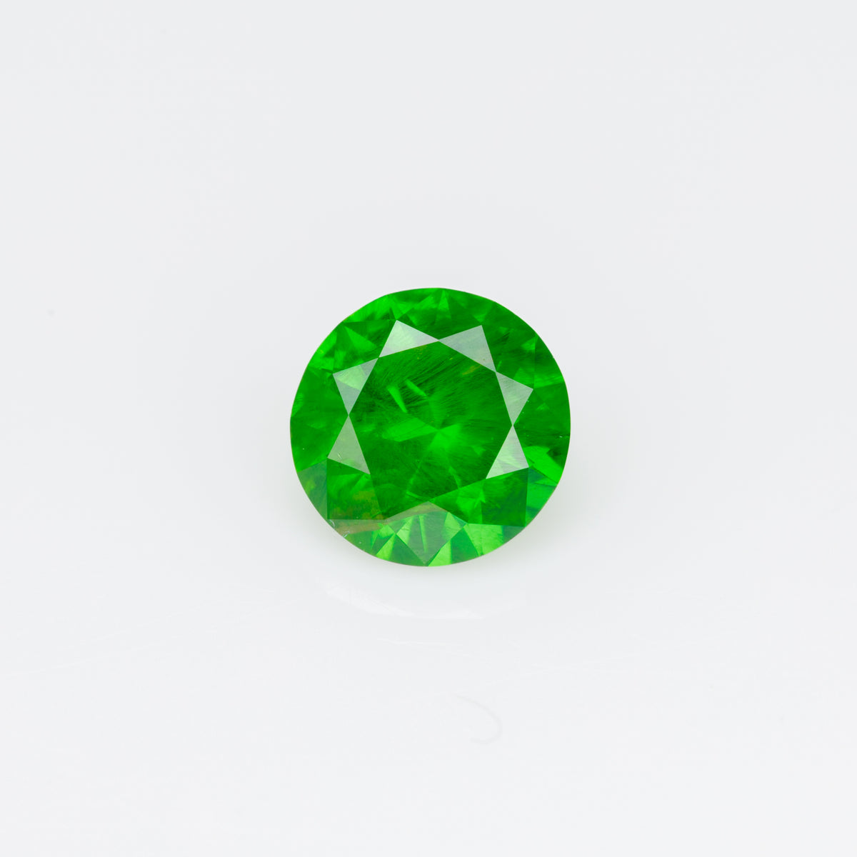 0.55 ct, Faceted Russian demantoid garnet with horsetail inclusion