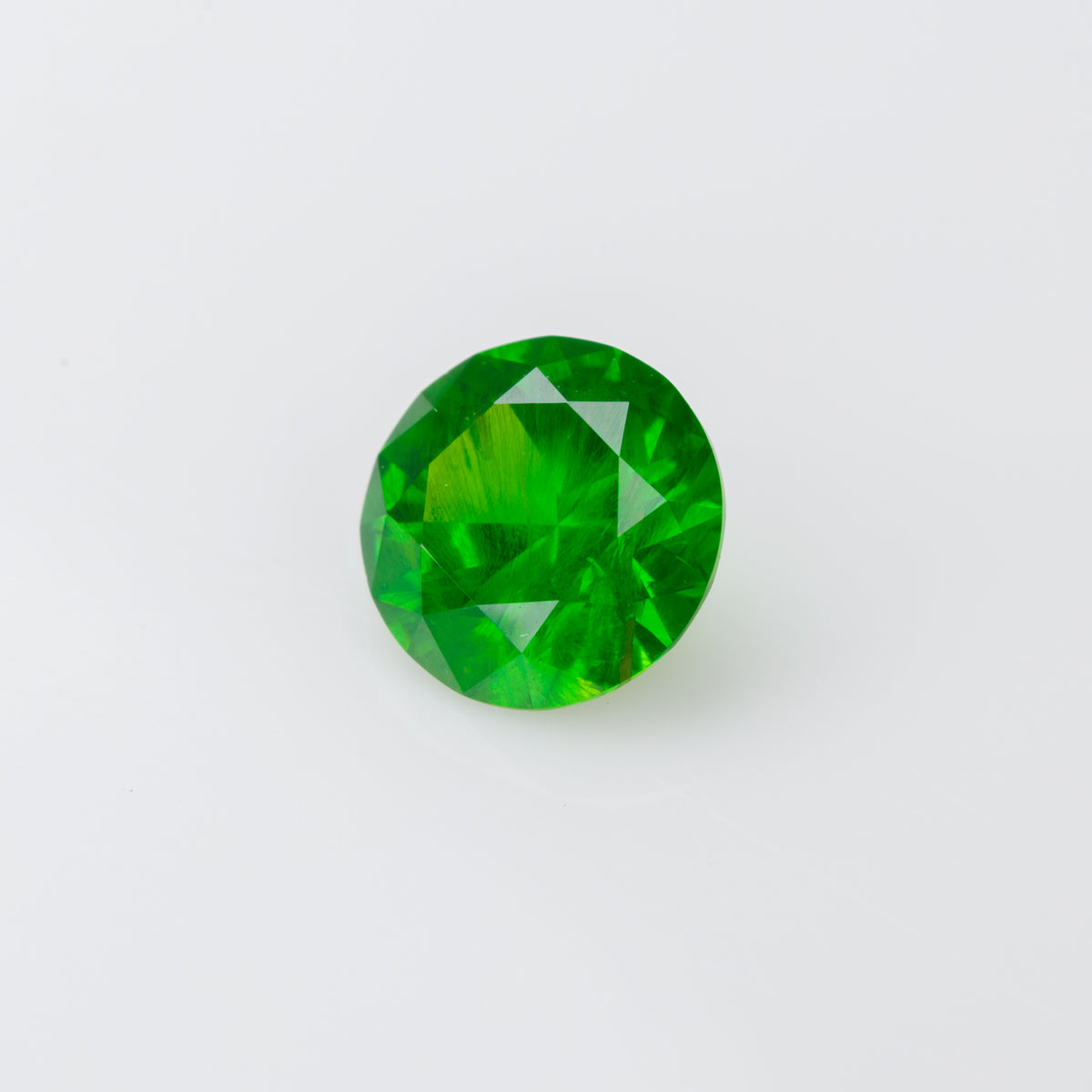 0.55 ct, Faceted Russian demantoid garnet with horsetail inclusion