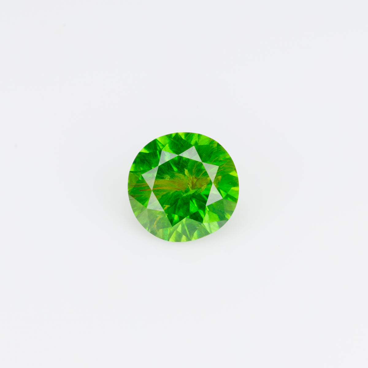 0.47 ct, Faceted Russian demantoid garnet with byssolite inclusion