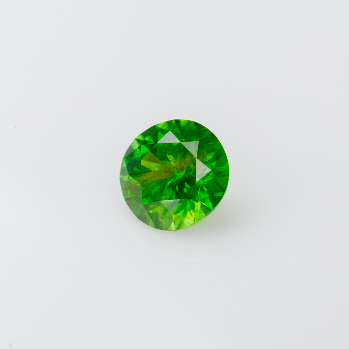 0.47 ct, Faceted Russian demantoid garnet with byssolite inclusion
