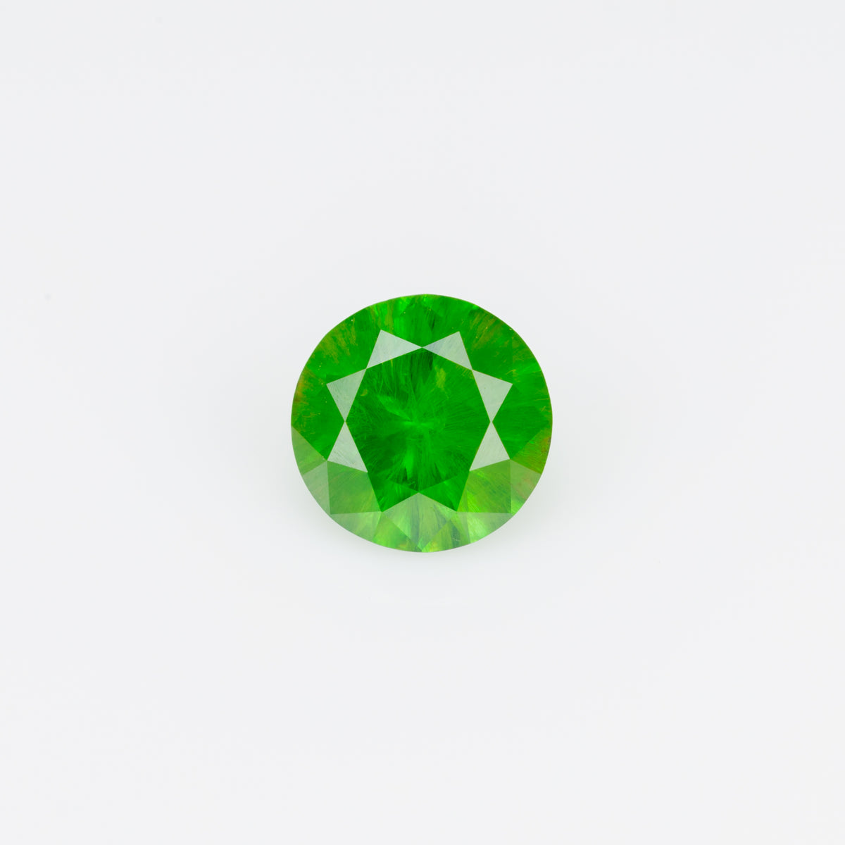 0.48 ct, Faceted Russian demantoid garnet with horsetail inclusion