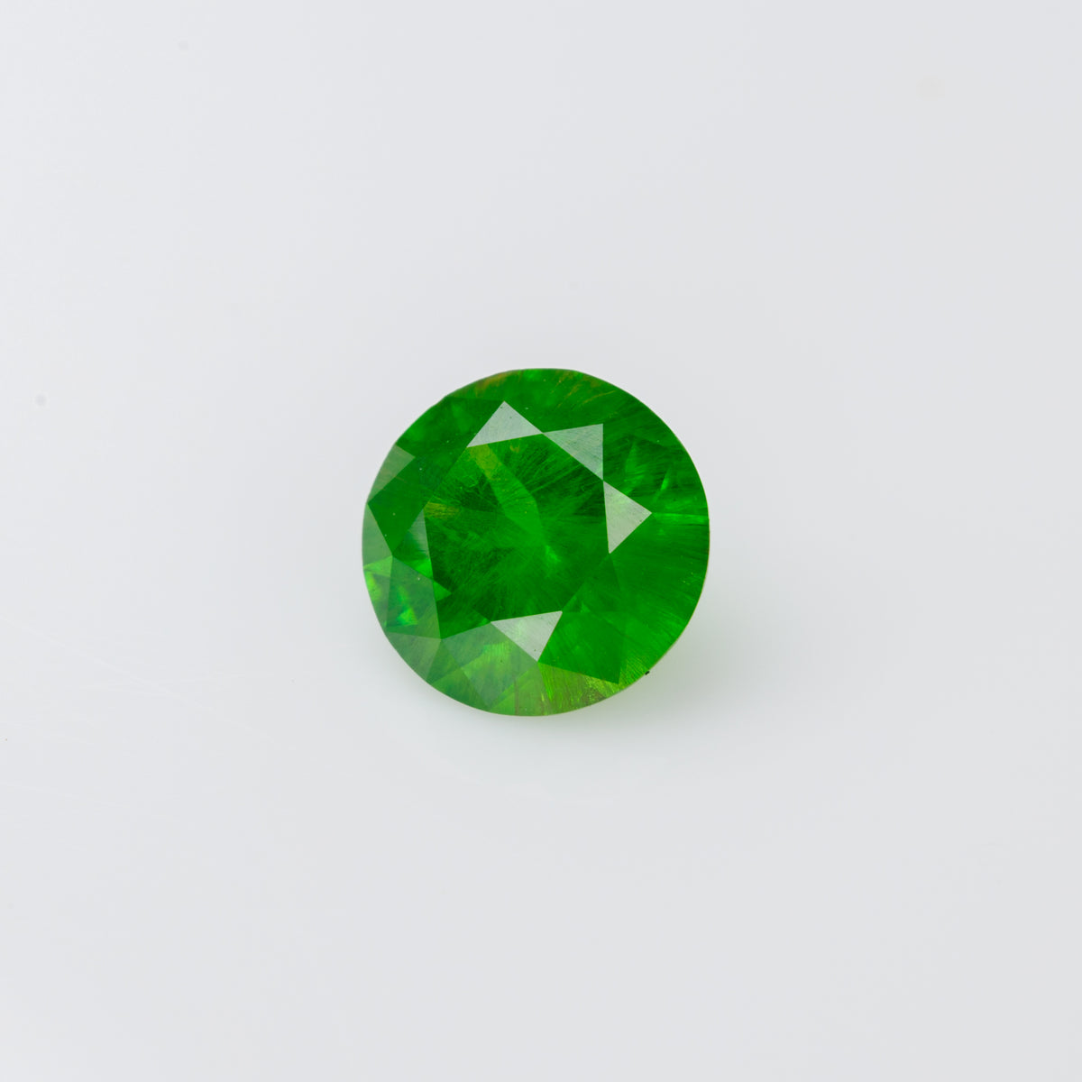 0.48 ct, Faceted Russian demantoid garnet with horsetail inclusion