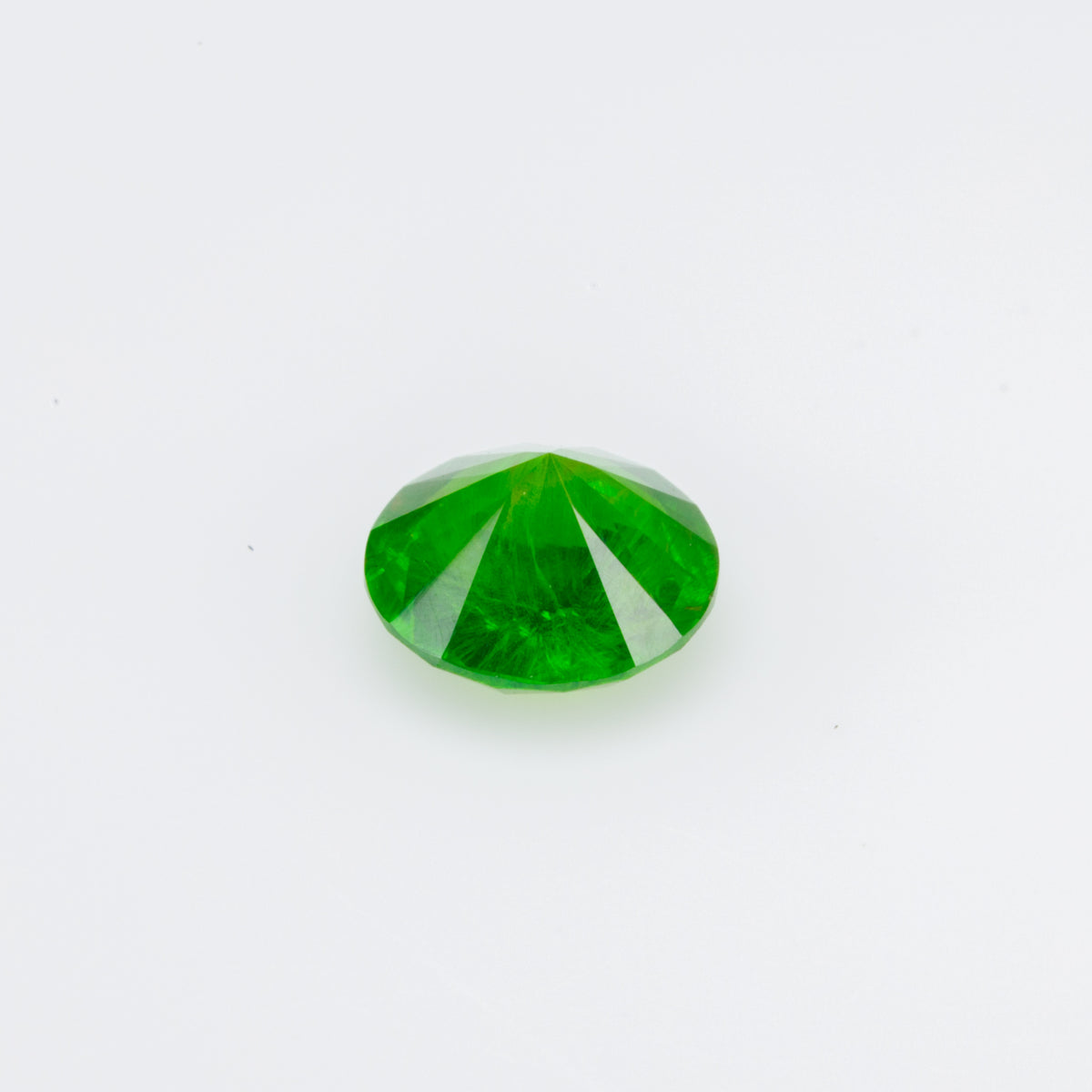 0.48 ct, Faceted Russian demantoid garnet with horsetail inclusion