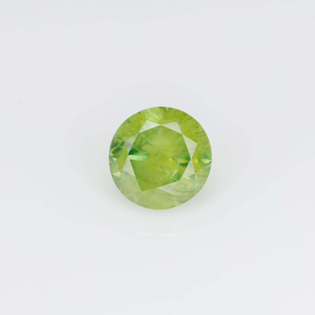 0.66 ct, Faceted Russian demantoid garnet with byssolite inclusions