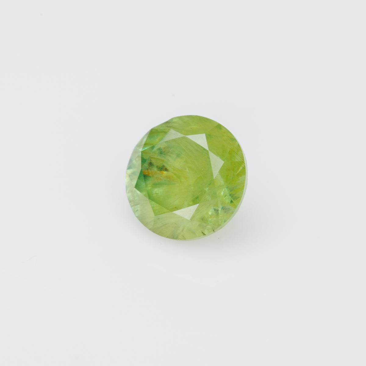 0.66 ct, Faceted Russian demantoid garnet with byssolite inclusions