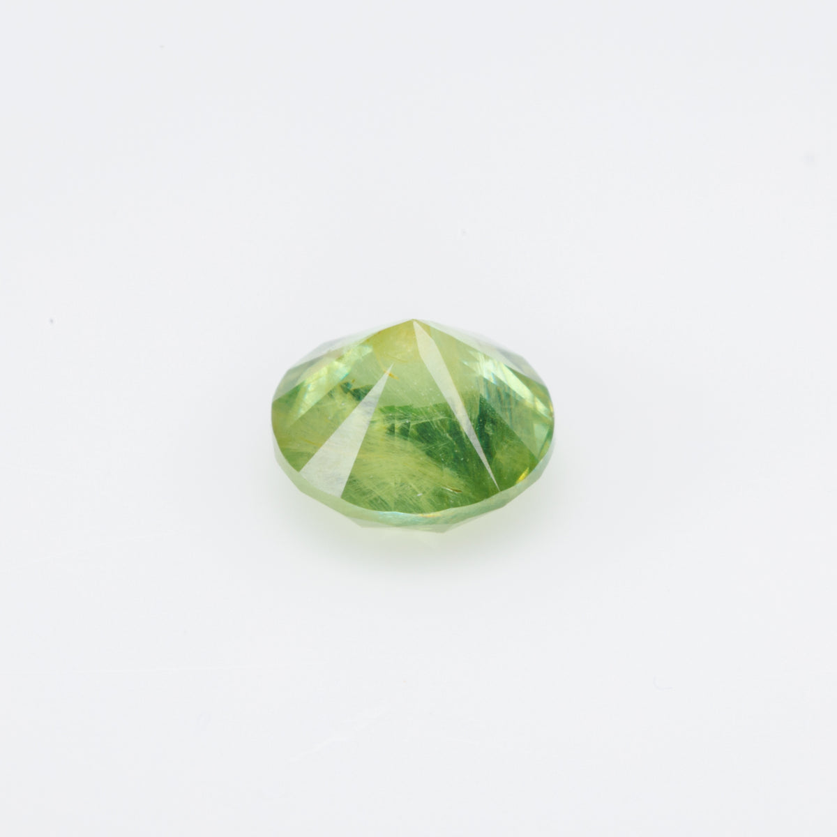 0.66 ct, Faceted Russian demantoid garnet with byssolite inclusions