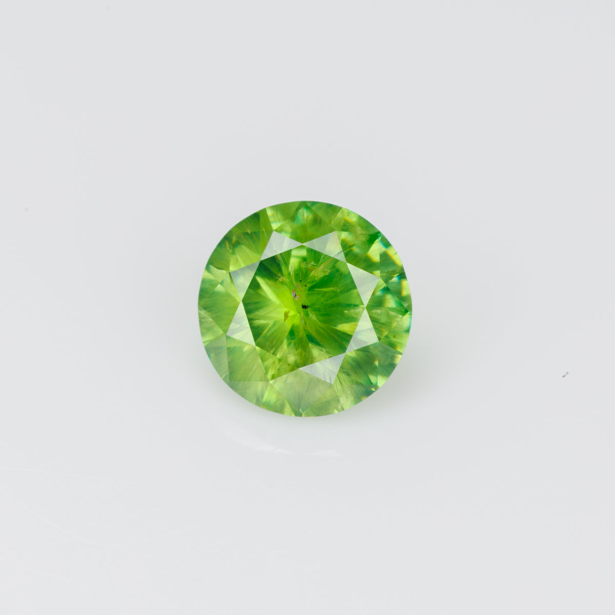 0.56 ct, Faceted Russian demantoid garnet with byssolite inclusions