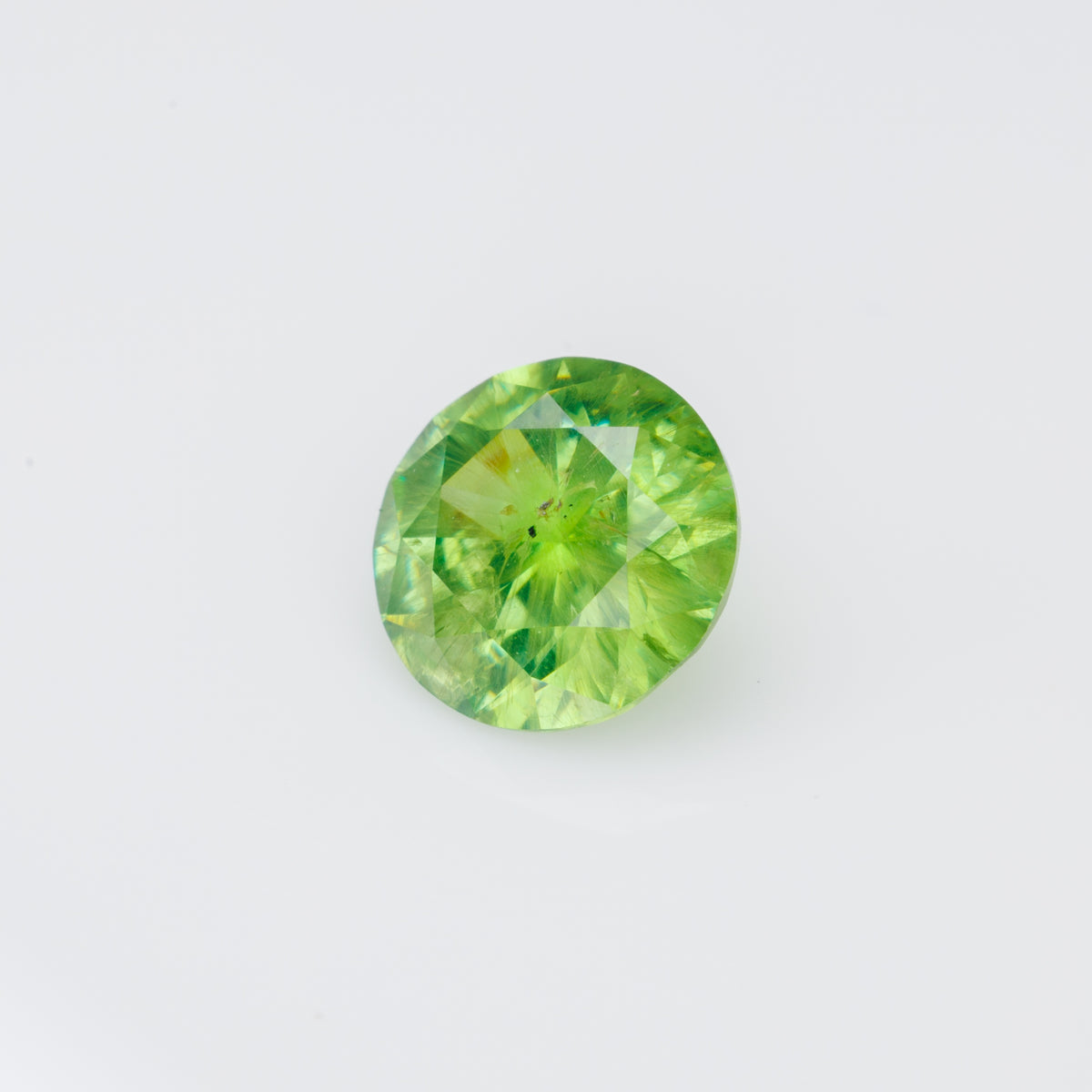 0.56 ct, Faceted Russian demantoid garnet with byssolite inclusions