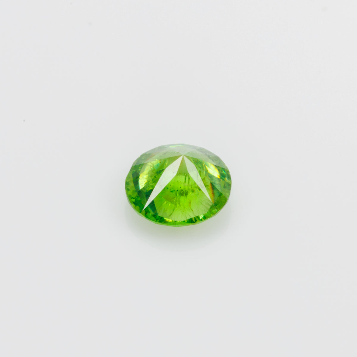 0.56 ct, Faceted Russian demantoid garnet with byssolite inclusions