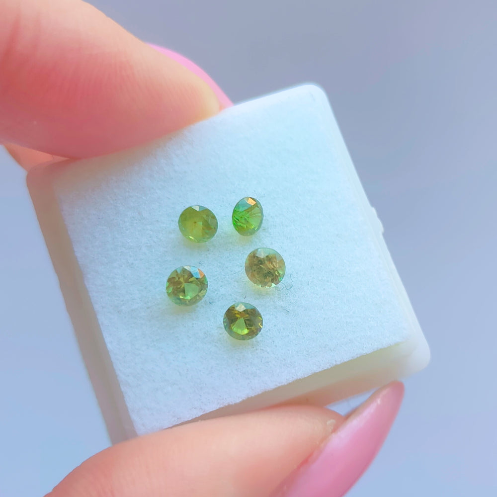Faceted demantoid garnet set