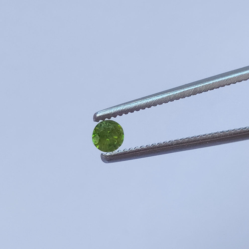 Faceted demantoid garnet set