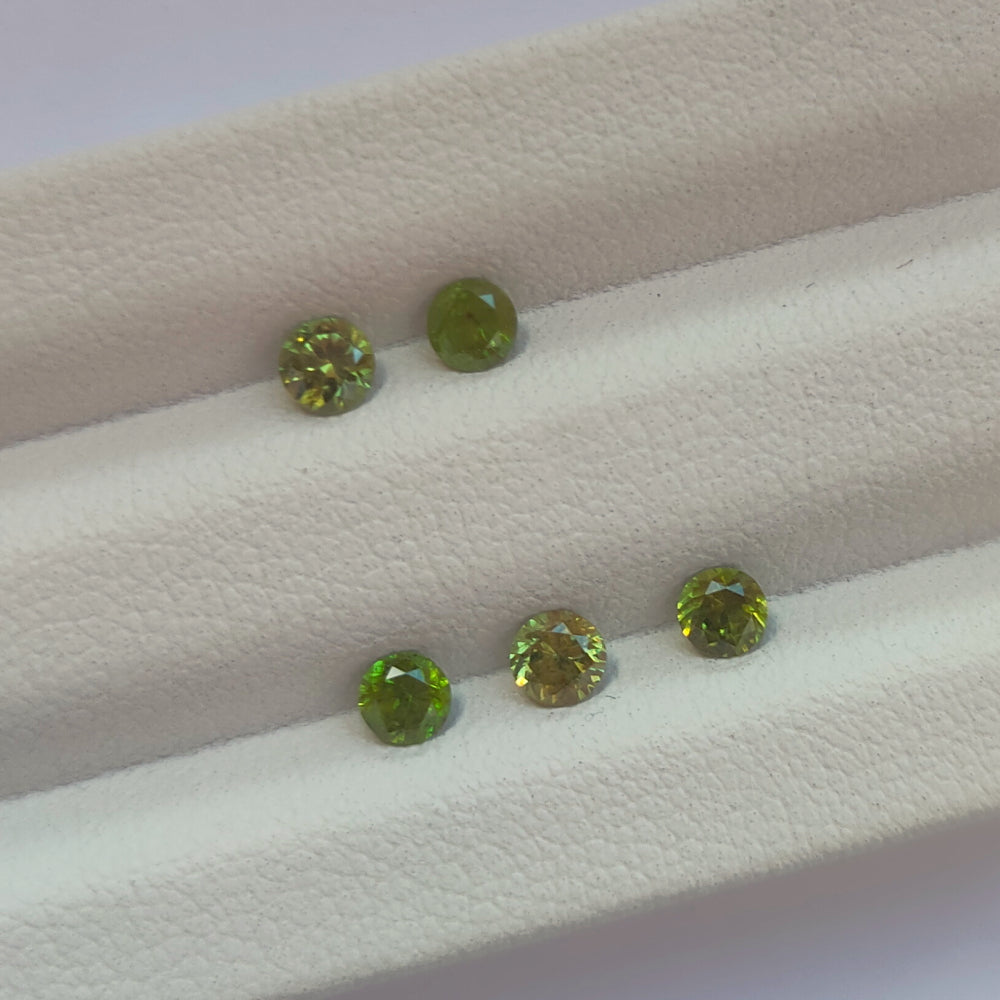 Faceted demantoid garnet set