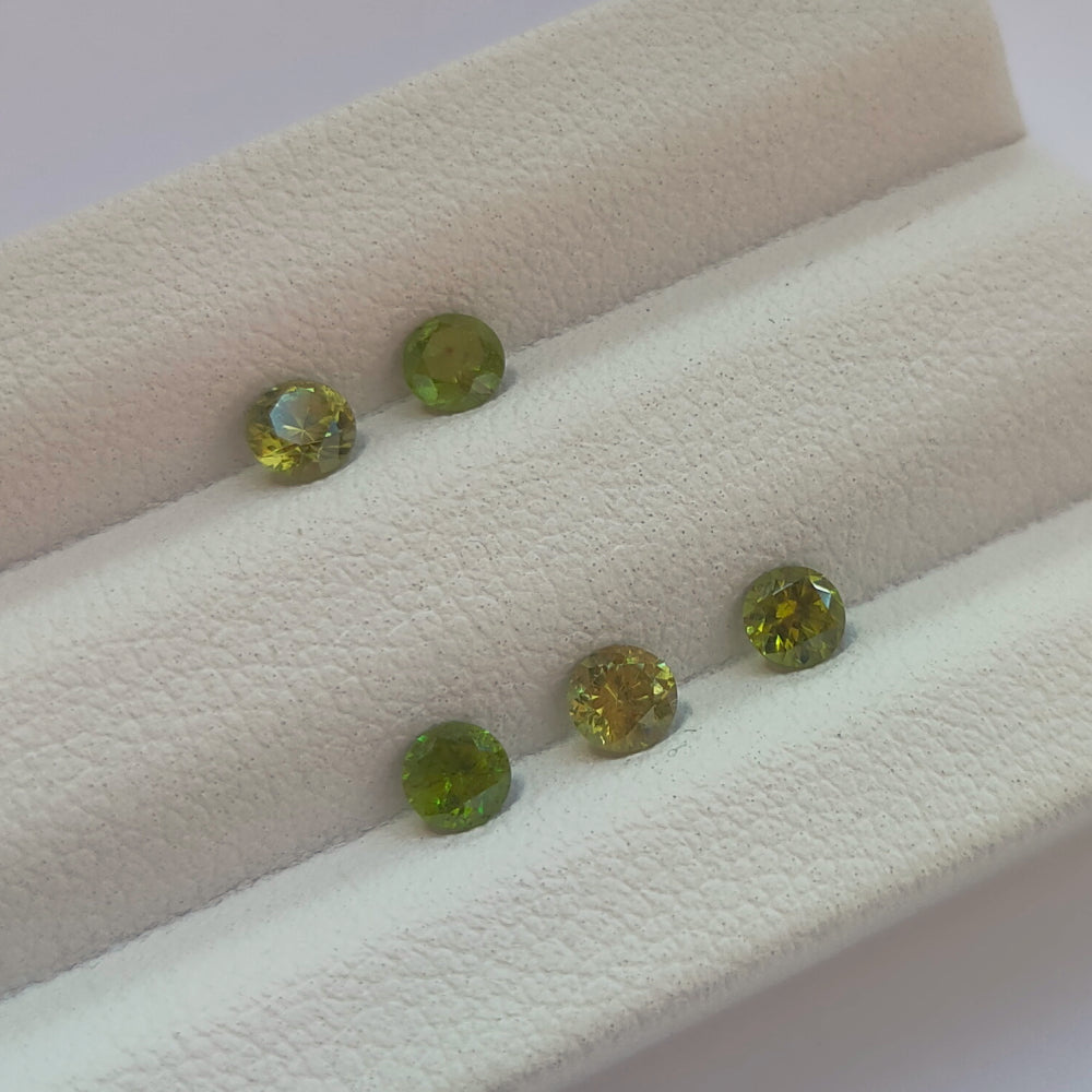 Faceted demantoid garnet set