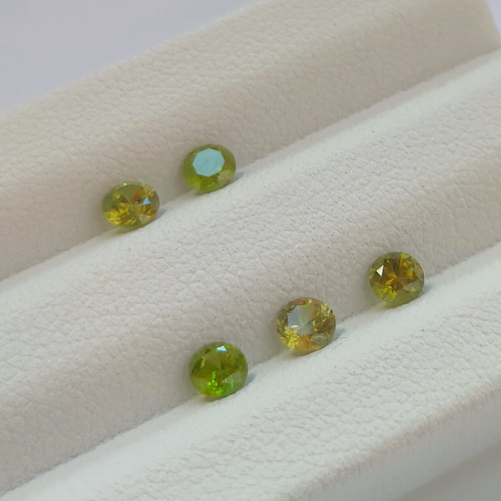 Faceted demantoid garnet set