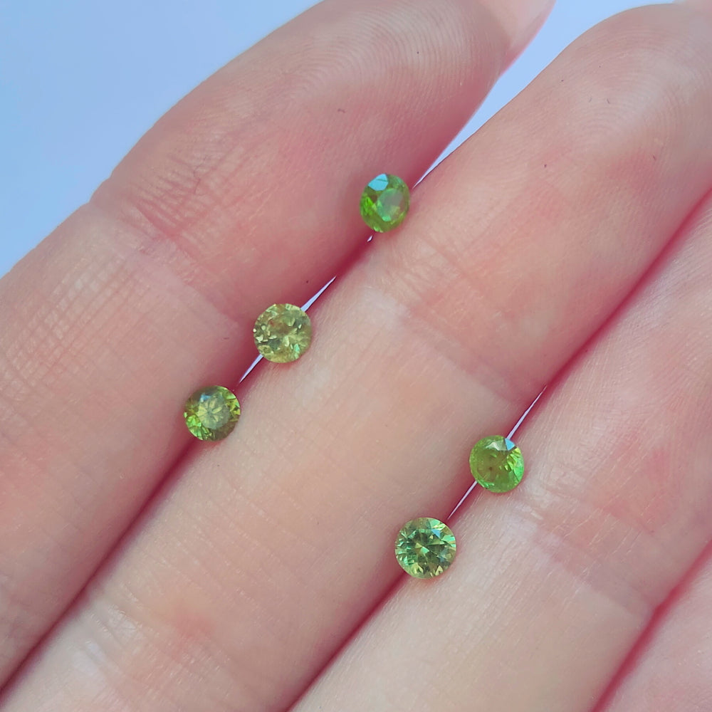 Faceted demantoid garnet set