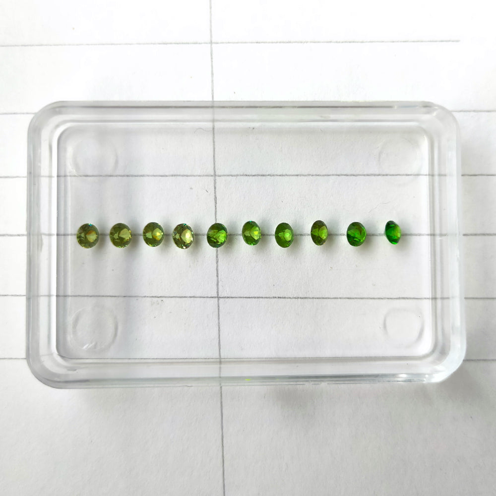 Faceted demantoid garnet set