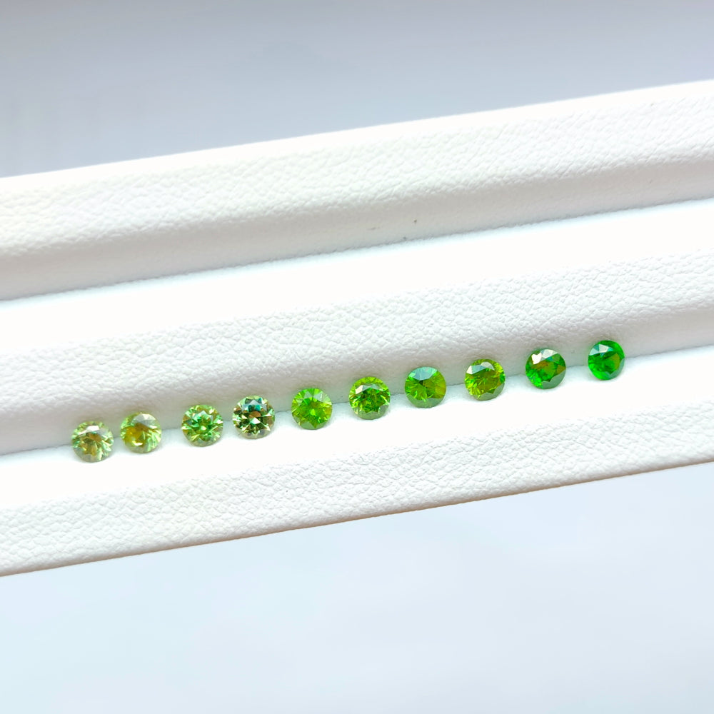 Faceted demantoid garnet set