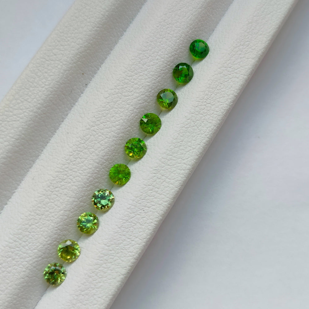 Faceted demantoid garnet set
