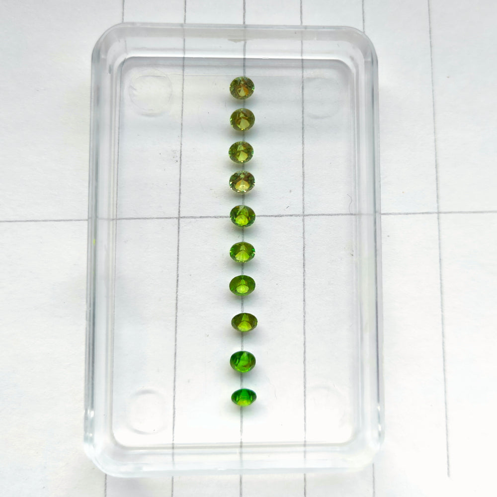 Faceted demantoid garnet set
