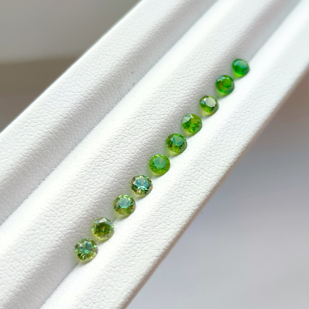 Faceted demantoid garnet set